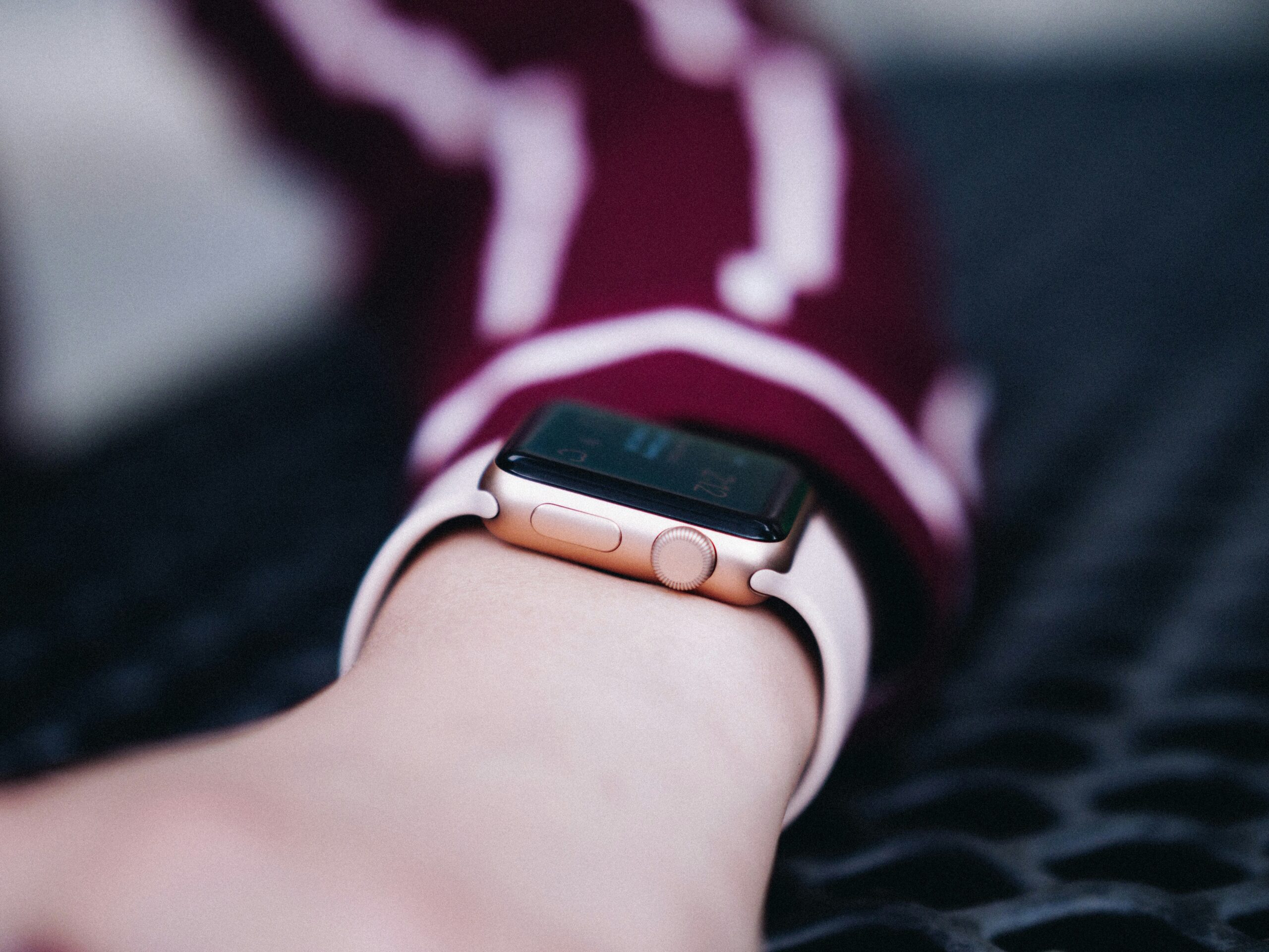 Jane wearing a stylish black leather-strapped smartwatch post-marathon finish line photo.
