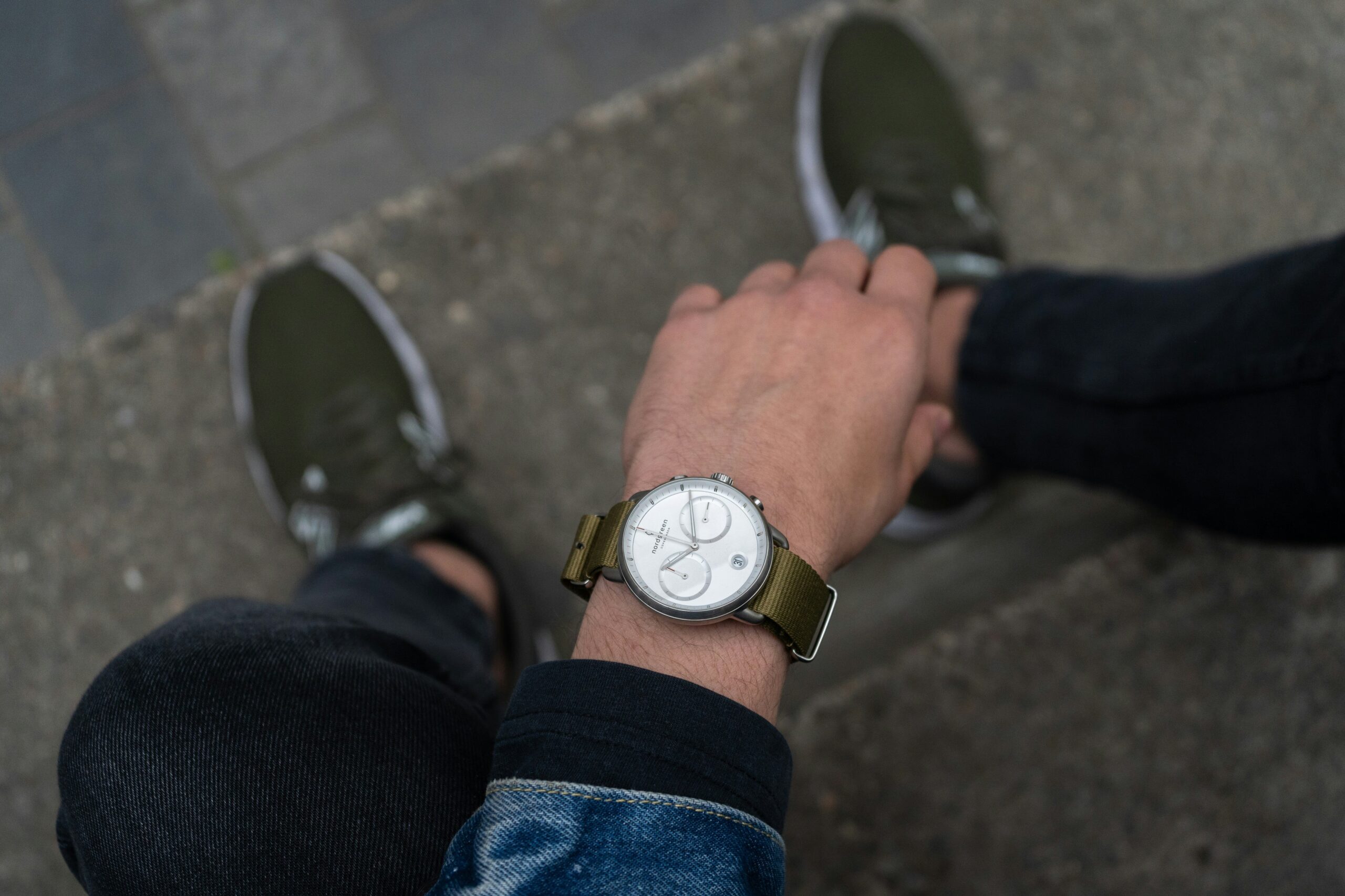 A woman wearing a turquoise-dialed smartwatch