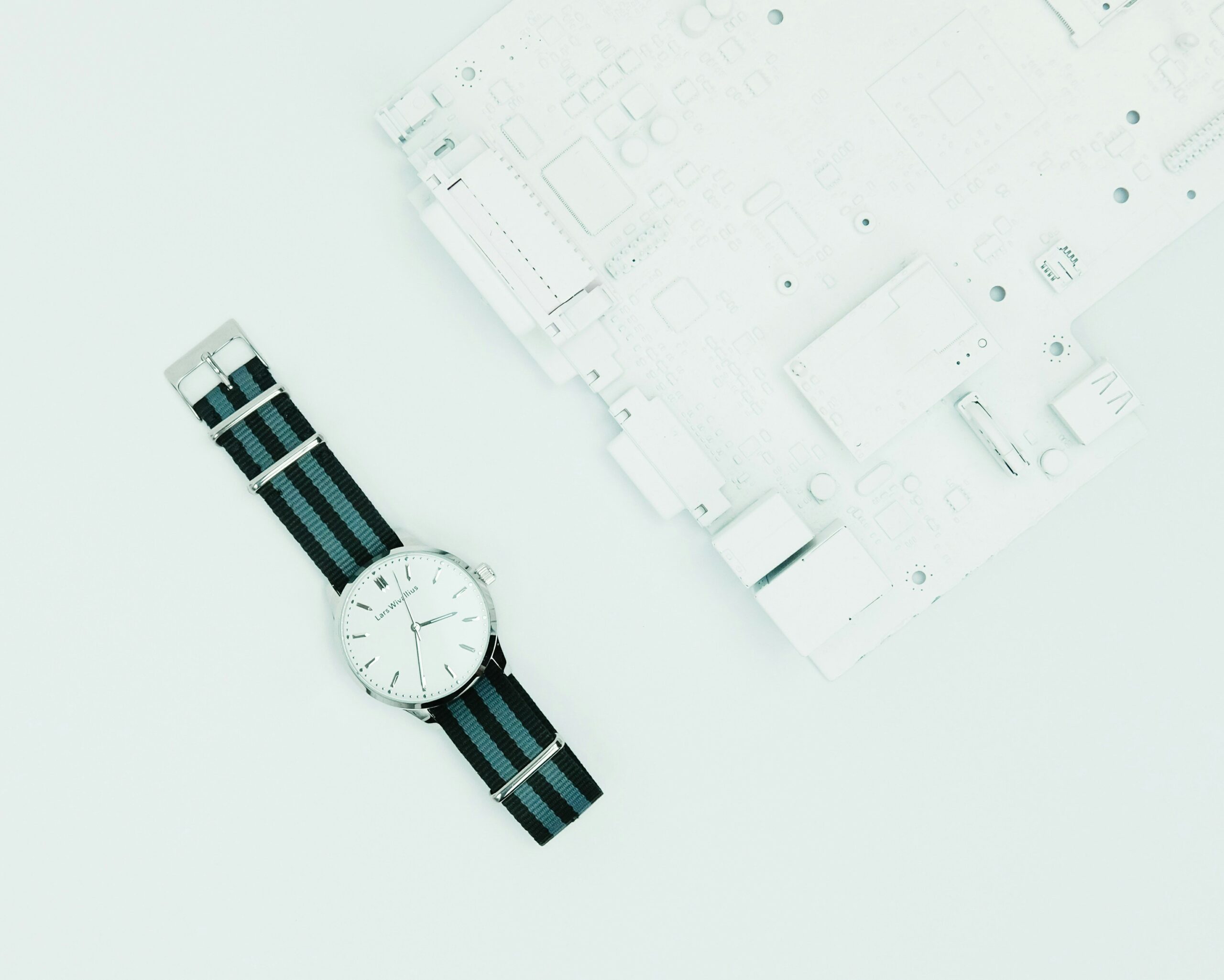 Multiple titanium watches displayed neatly on velvet fabric