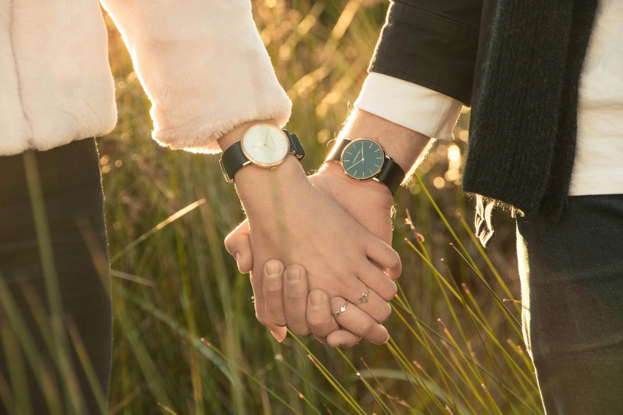 A close-up of a slim Citizen watch on a leather strap against a dark background
