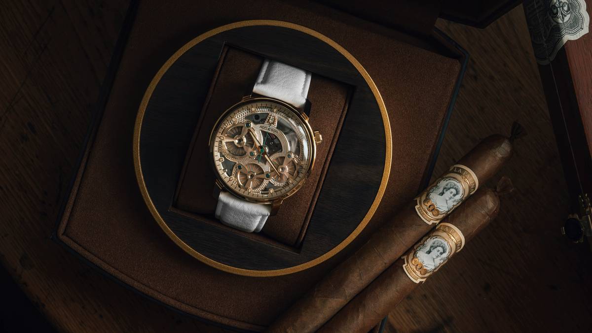 A person cleaning a luxury watch with a microfiber cloth