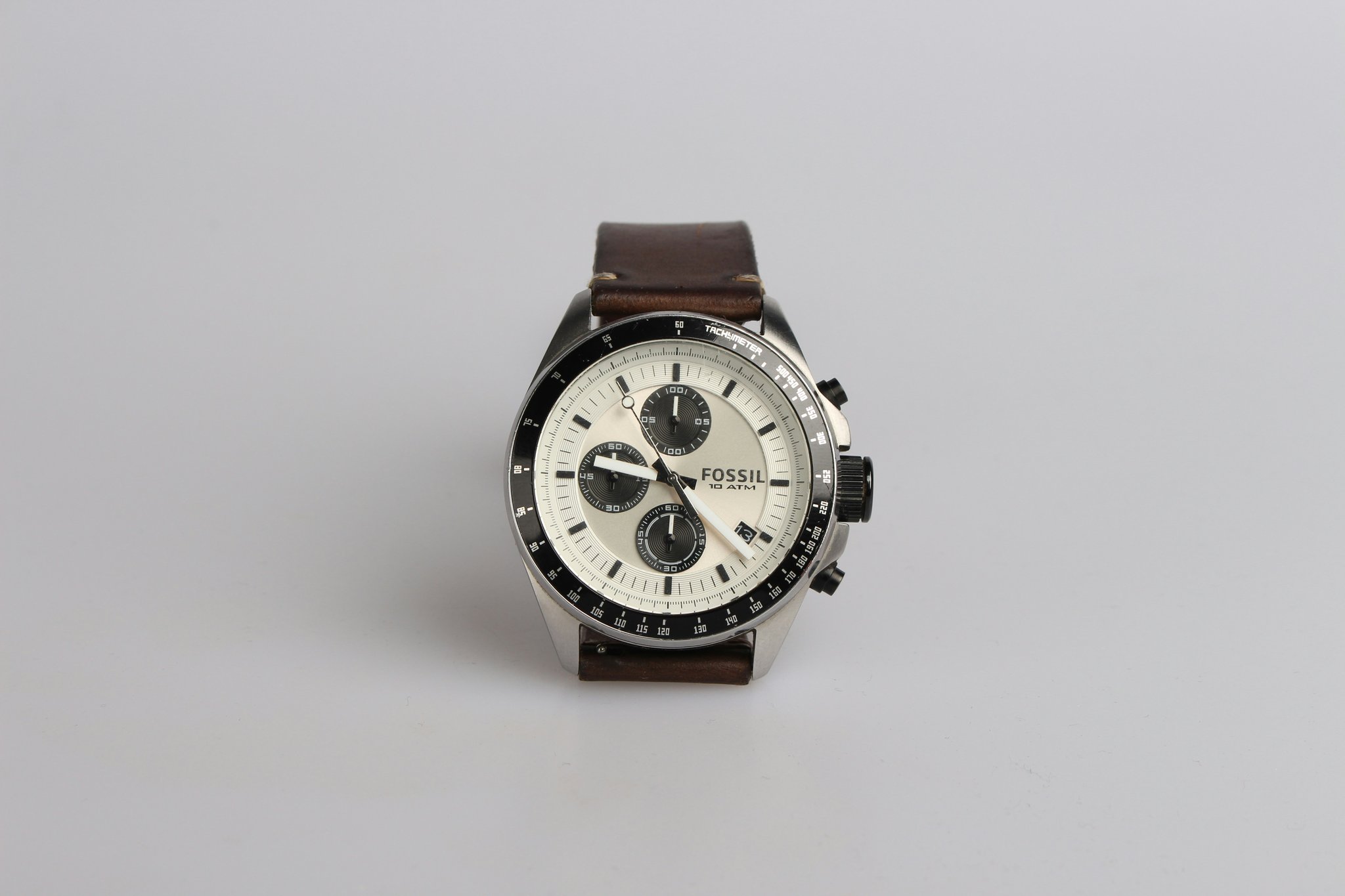 An image showing a variety of plain black and silver watches on a white background