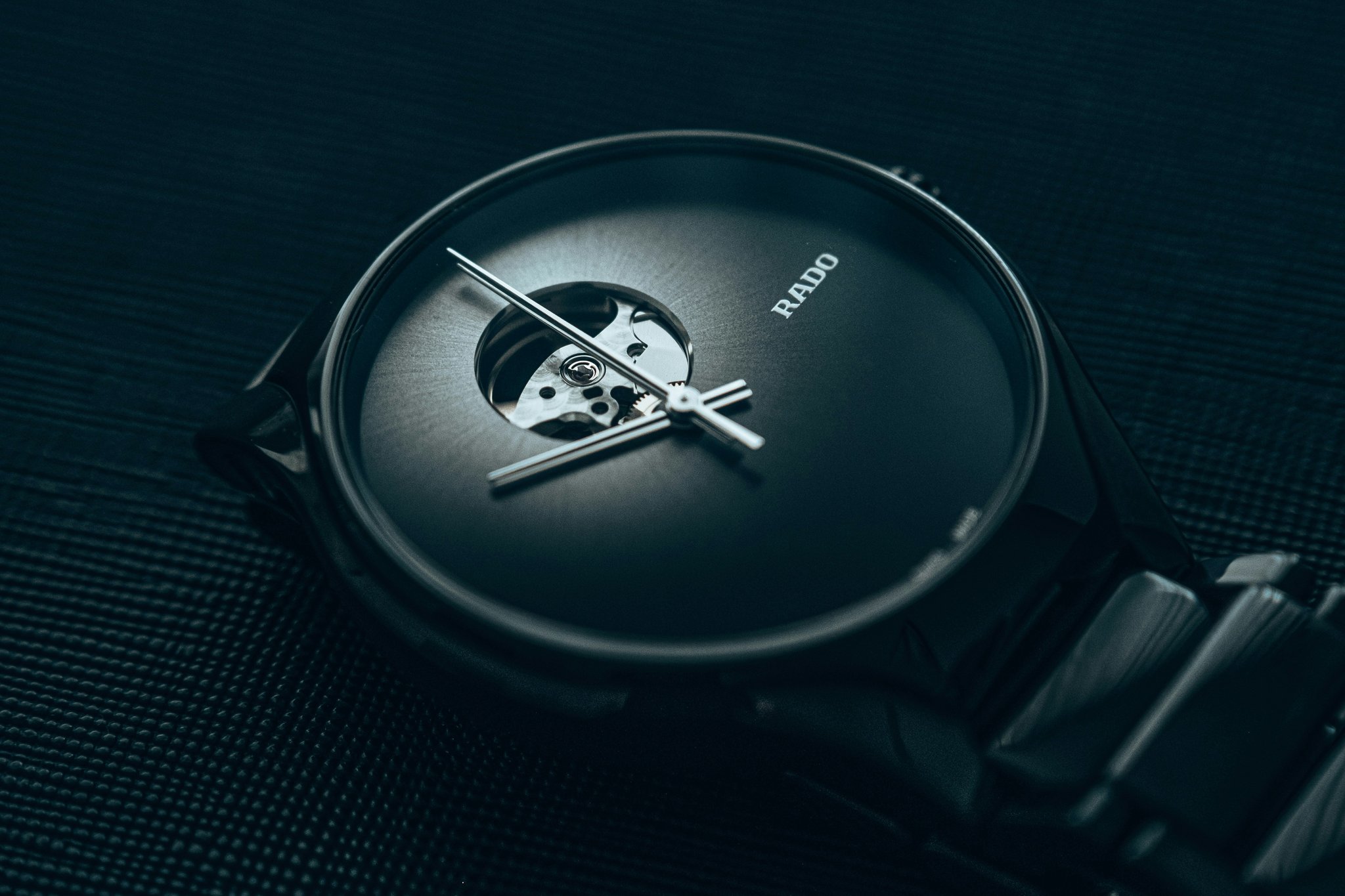 A collection of four elegantly designed aluminum fashion watches laid out on a white background.