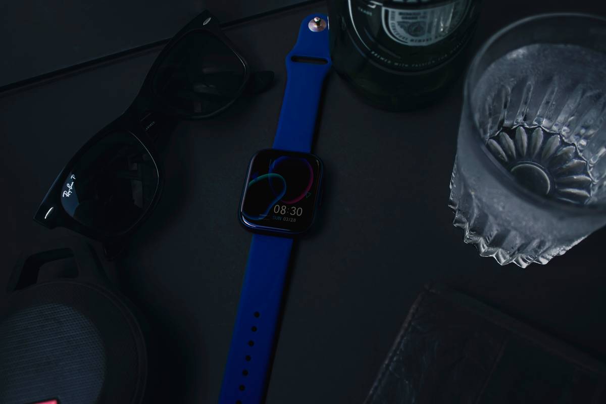 A model wearing a vibrant red plastic high-fashion watch paired with casual streetwear.