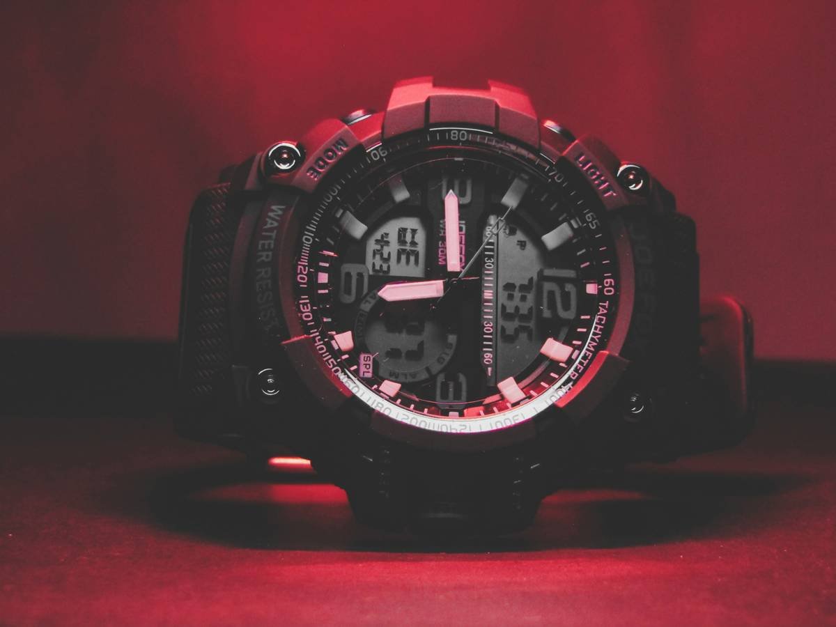 Side-by-side comparison of a bulky smartwatch vs. a slim digital dress watch on formal attire