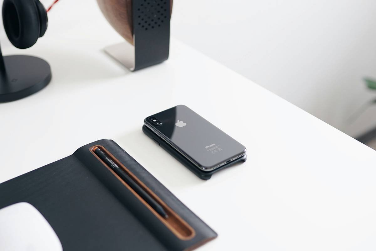 Stylish apple watch fashion setup with leather band and analog watch face on marble surface